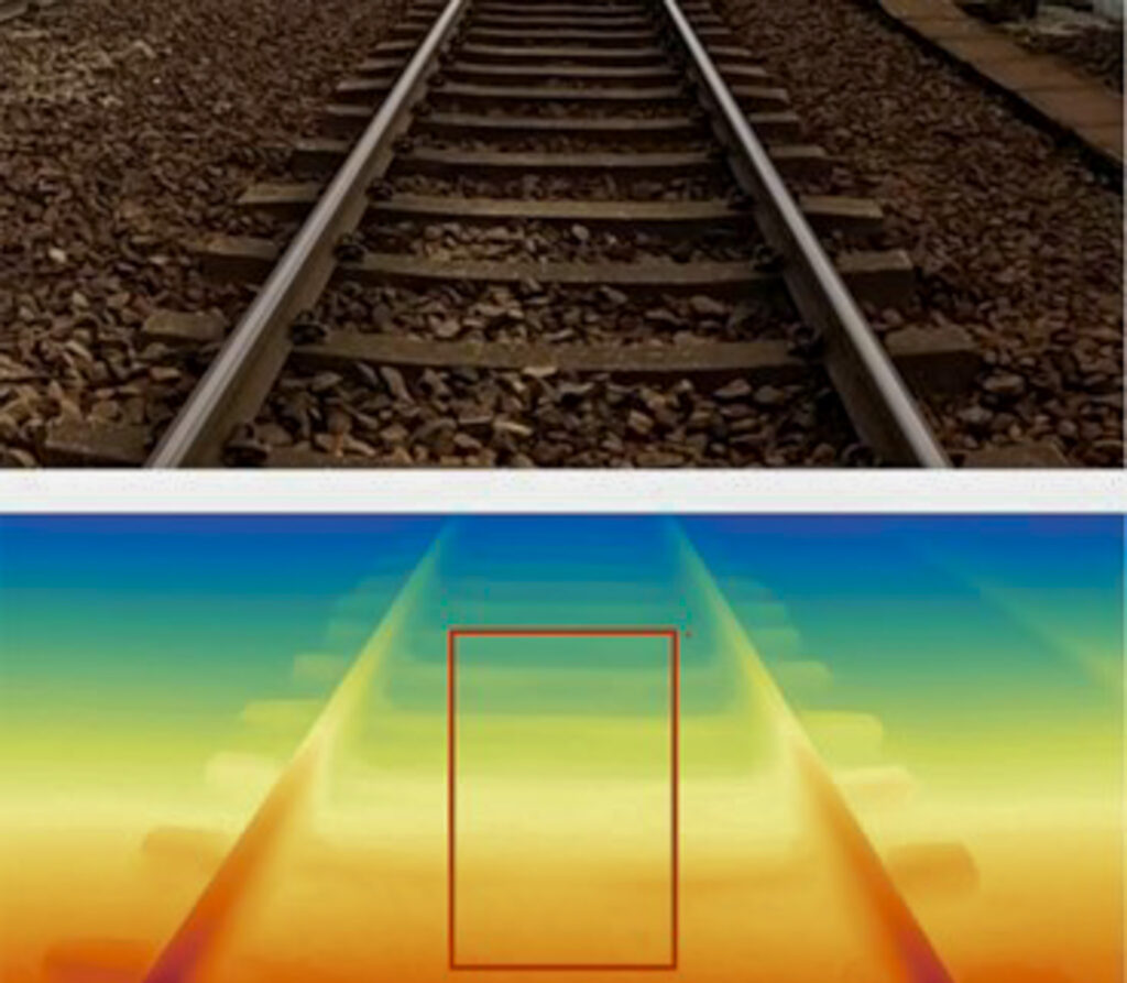 The image is split into two. The top photo is a regular photograph of the railway, featuring steel rails, tracks and sleepers. The bottom image is the same image, yet seen with computer vision in various colours. The problem area of the railway is outlined with a red rectangle.