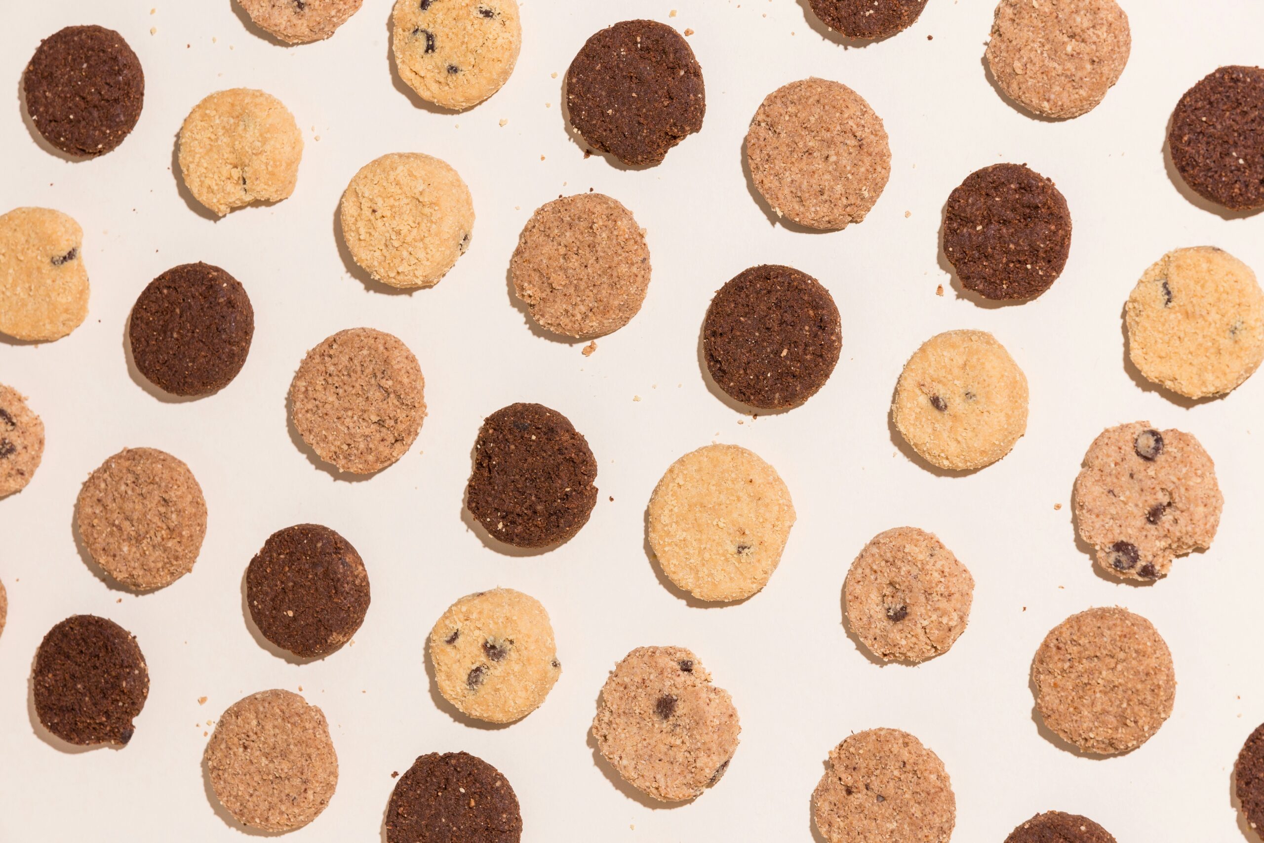 Flatlay of lots of different biscuits and cookies. Image: No Revisions via Unsplash
