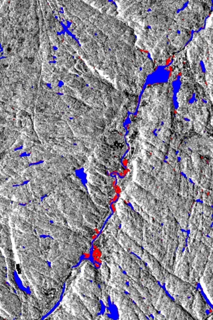 Satellite image showing flooding. Red areas indicate flooded regions, while blue areas mark rivers and lakes with normal water levels.